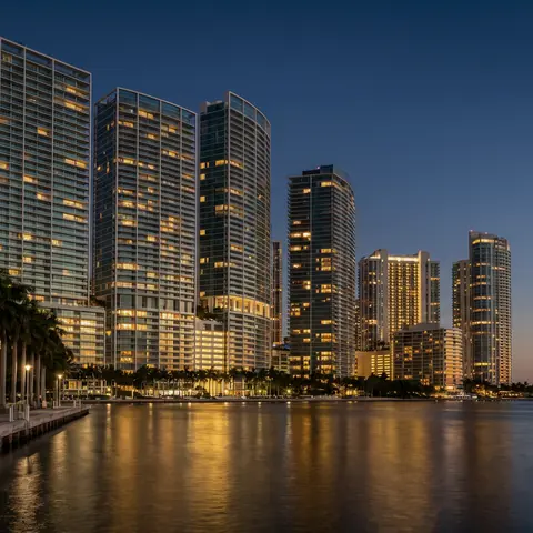 Glass condominium towers along the bay at dusk