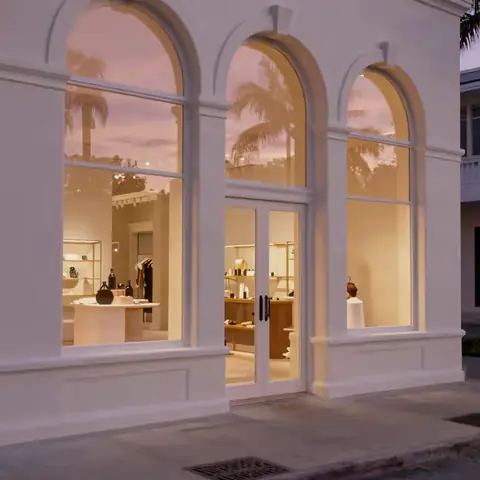 Arched storefronts glowing at dusk
